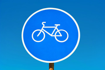 Bicycle path sign isolated on blue sky.