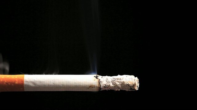 Time lapse of cigarette burning and smoking