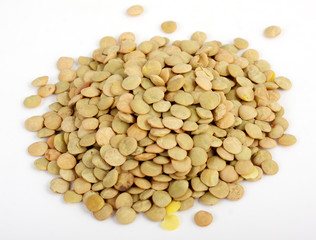 Lentil scattered on white background close up view
