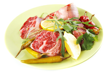 uncooked meat medallion on green