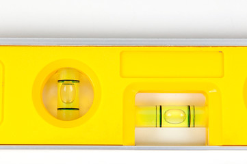 Yellow spirit level isolated on a white background