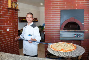 young man cooking pizza
