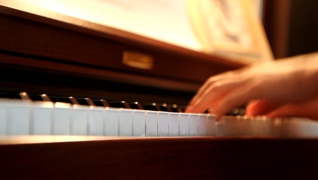 Men hands playing the piano with shallow depth of field