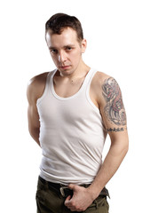 young man with tattoo in tank top  isolated