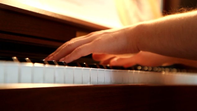 Men playing the piano with shallow depth of field closeup