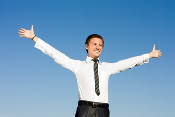 Successful business man with arms up