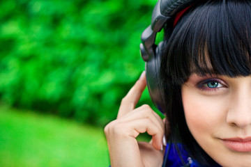 pretty young smiling woman listening music