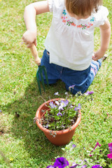 Little girl with a flowerpot