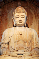 A golden Buddha sitting in the Asian Museum
