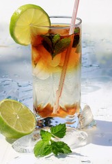 Mojito cocktail with lime, ice and mint leaves