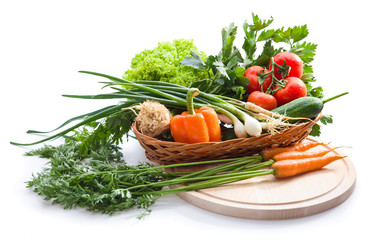 Fresh vegetables on cutting board on white background