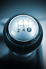 Car's shift lever. Five gears. Shiny chrome surface. Gearshift.