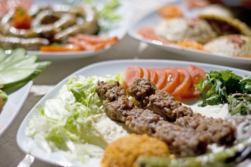 Traditional Turkish food Adana Kebab Served with bulgur pilaf, grilled tomatoe slices and green pepper,