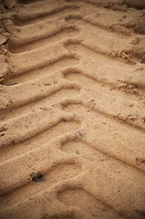 Tyre tread track on the sand.