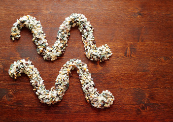 Zodiac sign Aquarius laid out from stones on a wooden surface