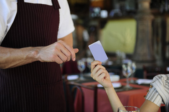 customer paying with credit card at the restaurant