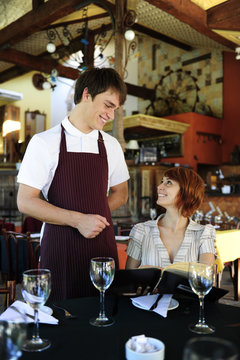 Waiter Talking To Costumer At The Restaurant