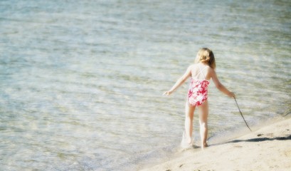 Fototapeta na wymiar Girl Playing In Water