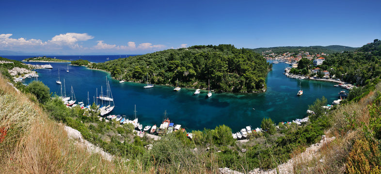 boats in bay on paxos island, greece
