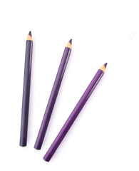 three violet eyebrow pencils on white