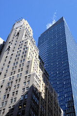 Fototapeta na wymiar Old building next to a towering modern glass skyscraper