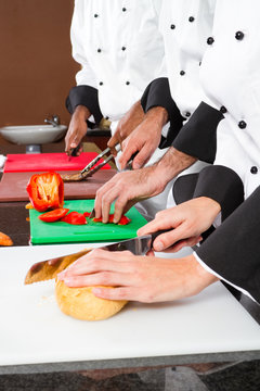 chefs preparing food in commercial kitchen
