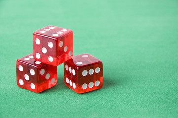 Red dice against green background