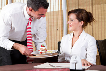 waiter brings the customer the ordered dessert