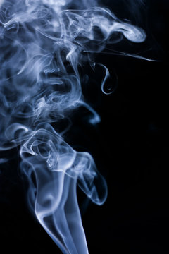 Stream of a blue smoke on a black background