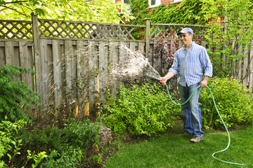 Man watering garden - 23988575