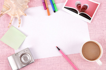 Clutter of objects stacked on pink background