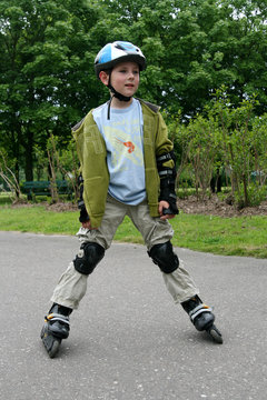 Preschooler learning to ride on rollerblades
