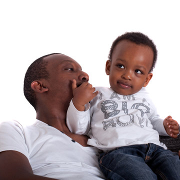 Young afro american family in a living room setting.