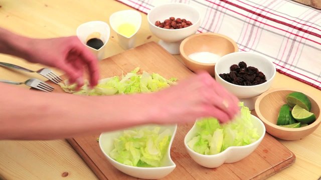 Two hands preparing healthy salad