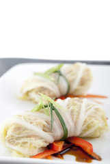 Cabbage roll appetizers with soy sauce garnish