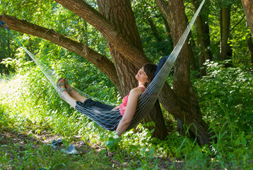 Woman relaxing in the hammock