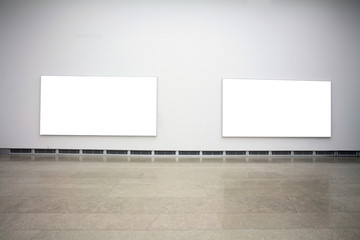 empty frames in a room against a white wall .