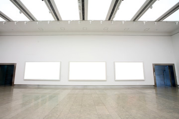 empty frames in a room against a white wall .