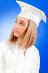 Happy graduate against colourful background