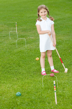 Little Girl Playing Croquet