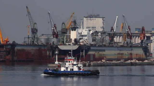 Tug-boat at the sea trading port (HD)