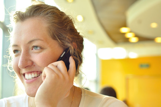 Woman Is Talking Phone And Looking Sideways