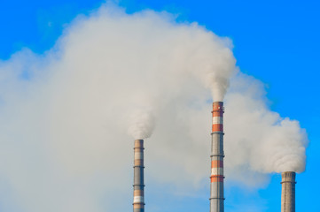 Smoke coming out of an industrial pipes