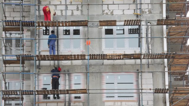 builders works on falsework in building area