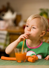 little girl with carrot juice