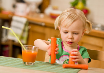 little girl with carrot juice