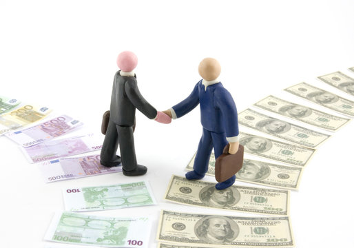 Two businessman figures shaking hands, on money paths.