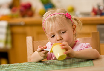 little girl eating yoghurt
