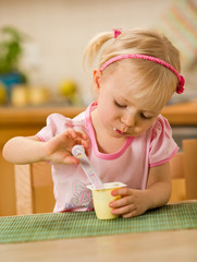 little girl eating yoghurt © mbt_studio