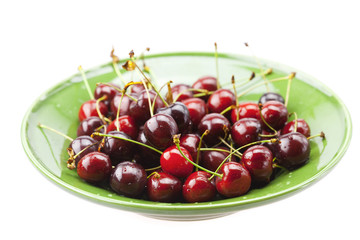 Cherries in a plate isolated on white